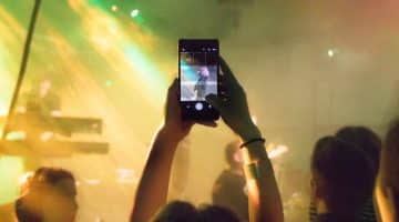 Someone holding up a phone to live stream a concert